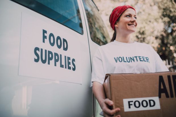 Community volunteer carrying groceries for local assistance