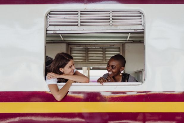 Happy passengers talking during a train ride