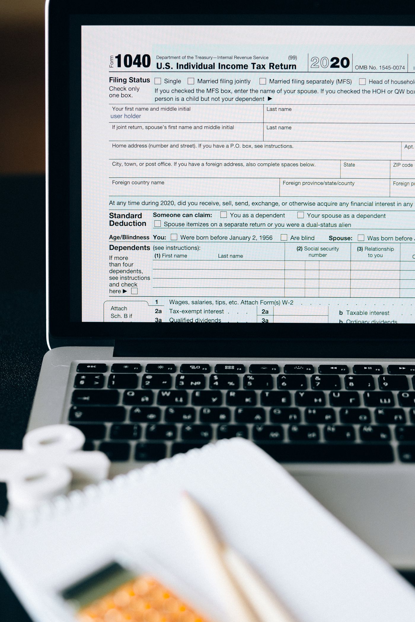Tax paperwork and laptop for preparing an income tax return