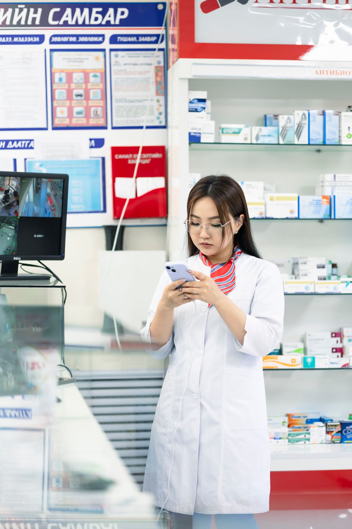 Pharmacist checking information in a pharmacy