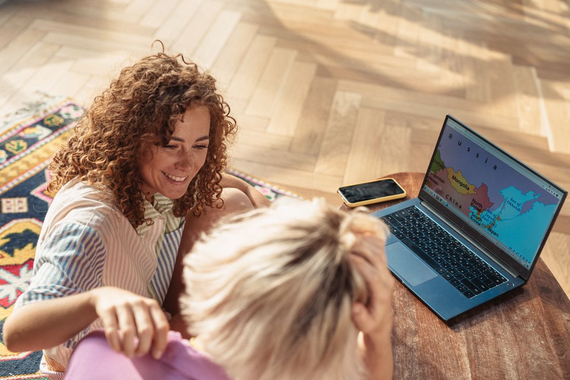 A couple using a laptop to compare options while planning a trip