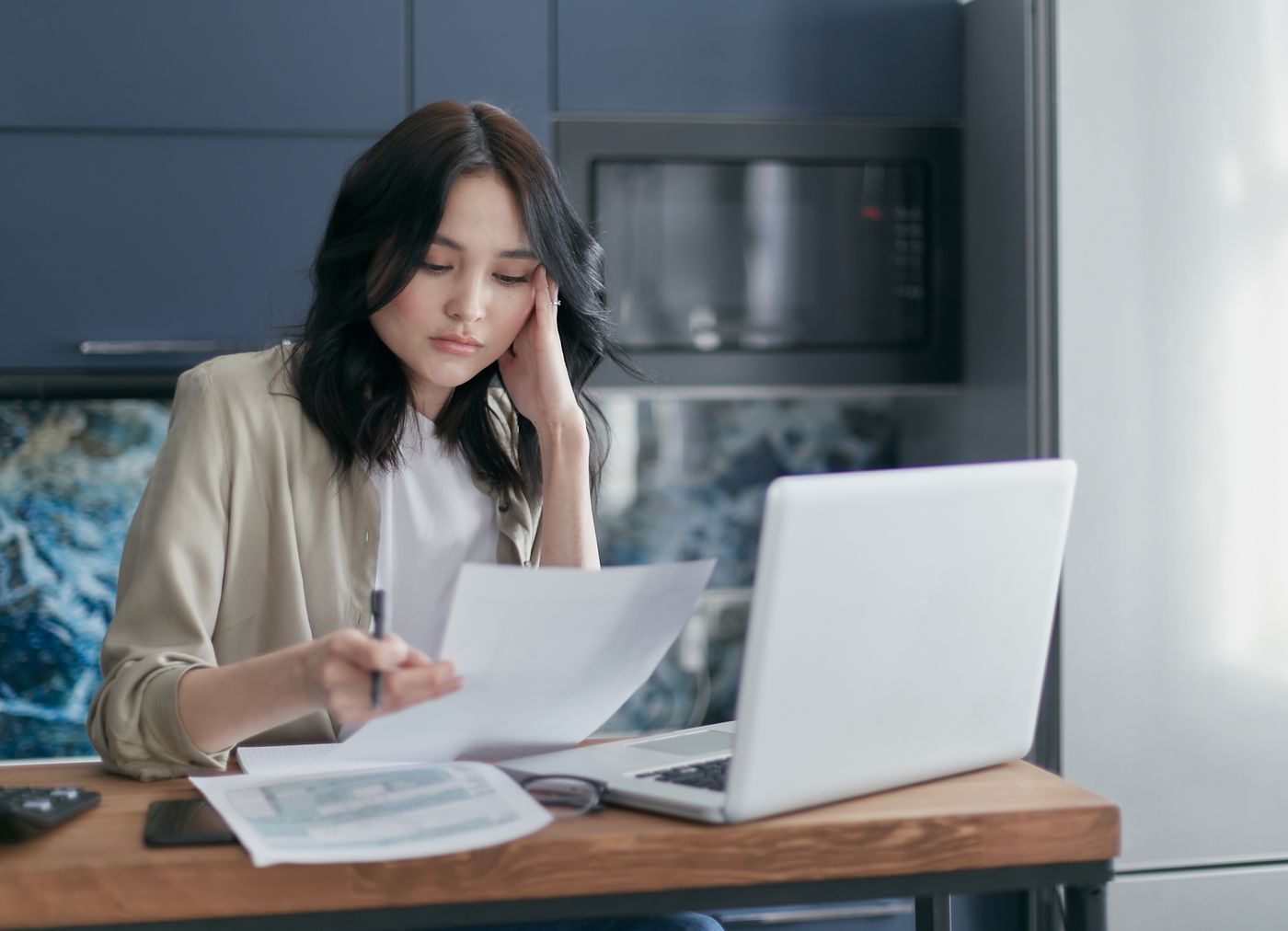 Woman reviewing prior account records at home